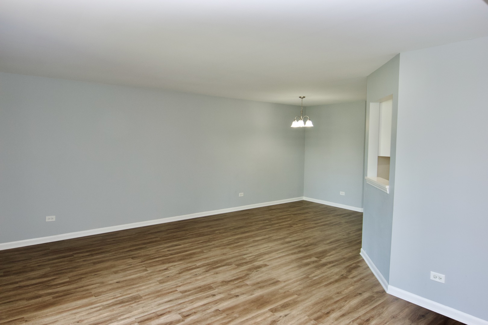 10347 Dearlove Road, Unit 301 Glenview, IL 60025 - Photo 7 of 13 a view of an empty room and wooden floor