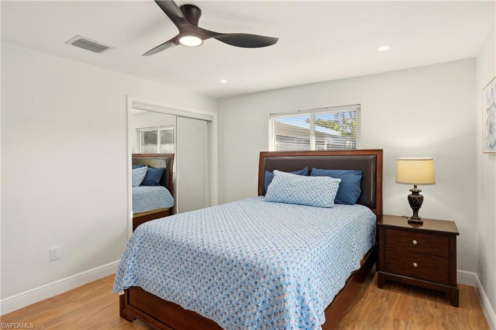 339 Landmark Street Marco Island, FL 34145 - Photo 20 of 50 Bedroom featuring a closet, ceiling fan, light wood-style floors, and recessed lighting