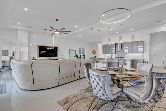 a bedroom with a bed a table and a large window