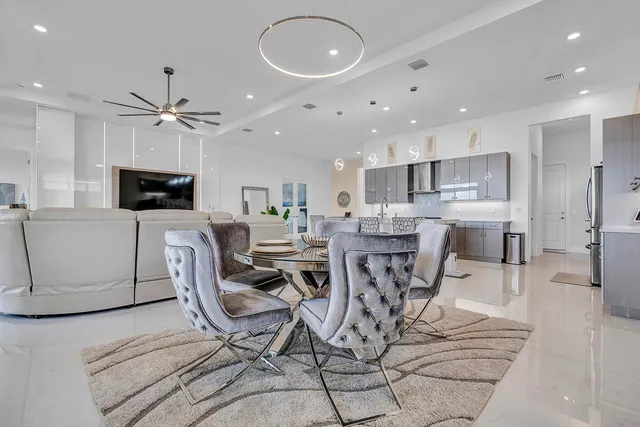 a bedroom with a bed and a flat tv screen on the dresser