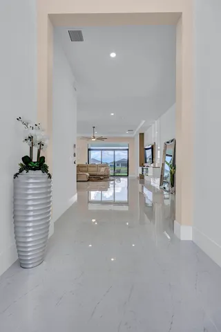 a white toilet sitting next to a white wall