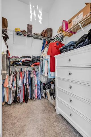 a view of a patio with table and chairs potted plants and floor to ceiling window