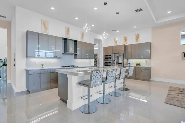 a kitchen with stainless steel appliances a refrigerator and cabinets