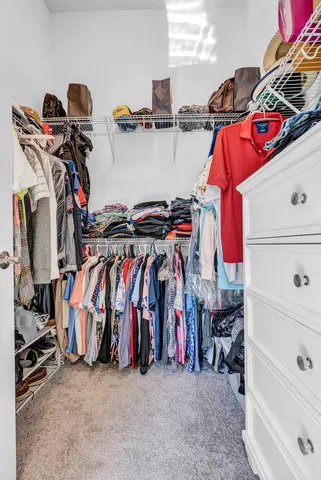 a living room with patio furniture and a floor to ceiling window