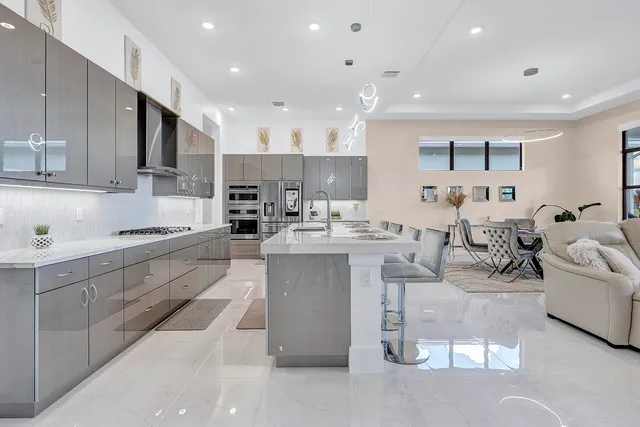 a large kitchen with kitchen island a sink stainless steel appliances and cabinets