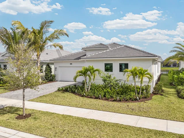 an aerial view of a house with yard swimming pool and ocean view