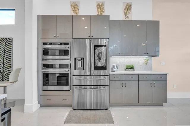 a kitchen with stainless steel appliances a sink stove top oven and cabinets