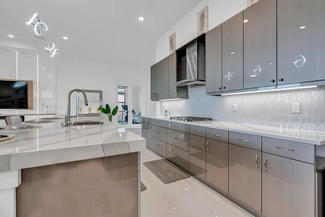 a kitchen with stainless steel appliances kitchen island granite countertop a sink and cabinets