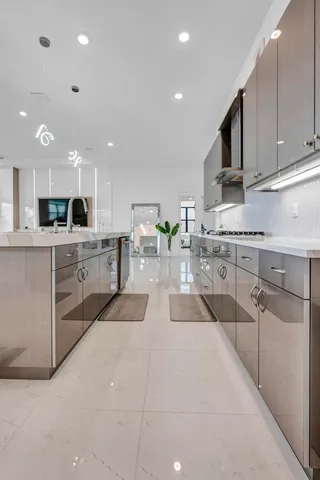 a living room with furniture kitchen view and a chandelier