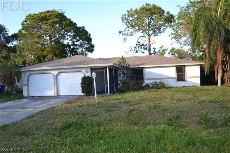 9185 Pomelo Road East Fort Myers, FL 33967 - Photo 1 of 13 a front view of a house with a yard and garage