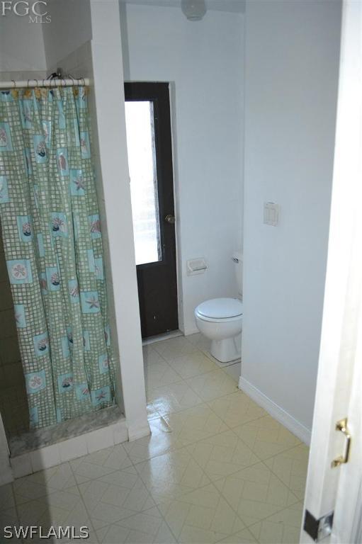 9185 Pomelo Road East Fort Myers, FL 33967 - Photo 12 of 13 a bathroom with a toilet and a shower