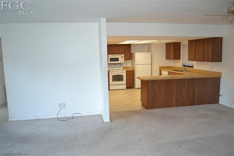 9185 Pomelo Road East Fort Myers, FL 33967 - Photo 4 of 13 a kitchen with stainless steel appliances granite countertop a stove and a sink