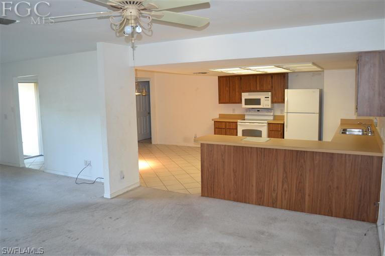 9185 Pomelo Road East Fort Myers, FL 33967 - Photo 6 of 13 en empty room with windows and ceiling fan