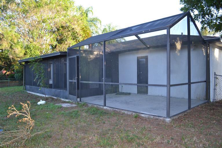 9185 Pomelo Road East Fort Myers, FL 33967 - Photo 8 of 13 a view of backyard with tub and trees