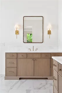a bathroom with a sink vanity and mirror