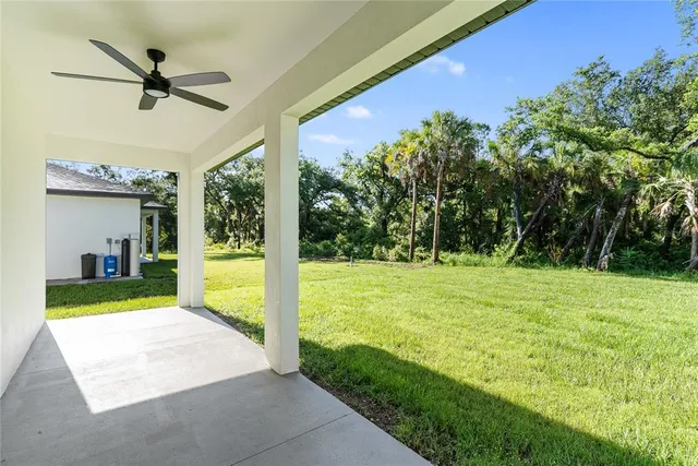 a kitchen with granite countertop a stove and a white cabinets