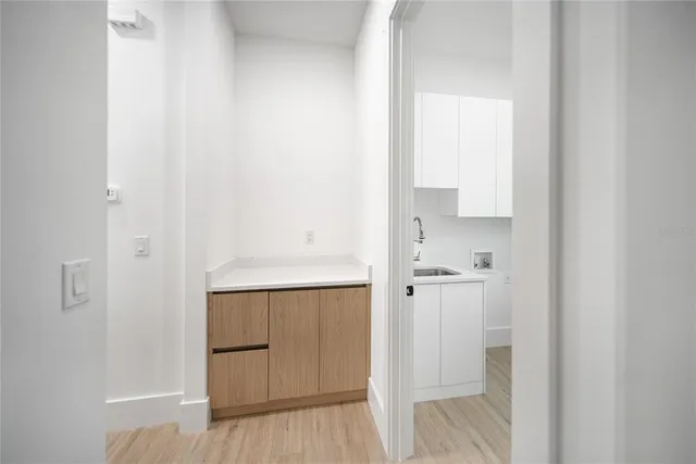 a view of a room with wooden floor and ceiling fan