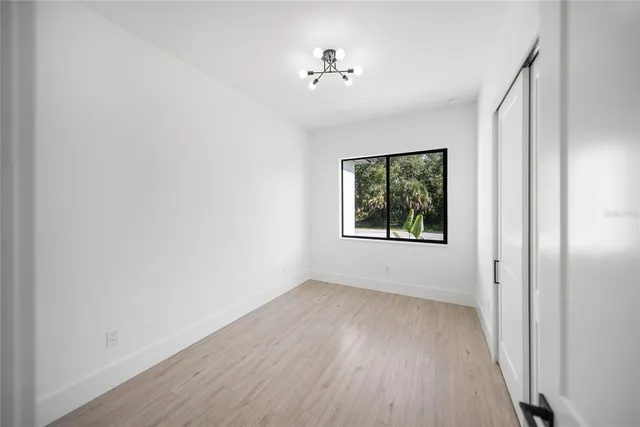 a view of a kitchen with wooden floor and a sink
