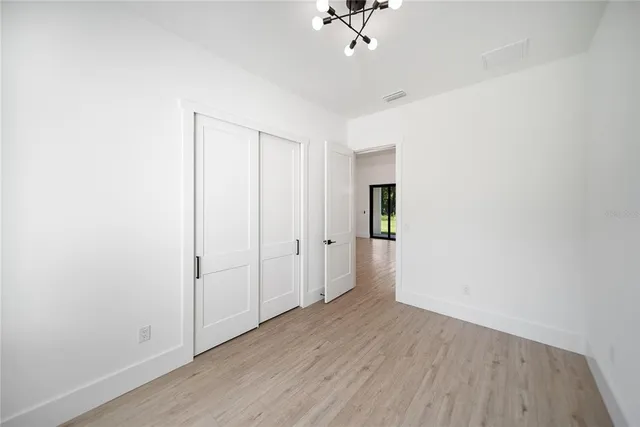 a kitchen with a sink cabinets and wooden floor