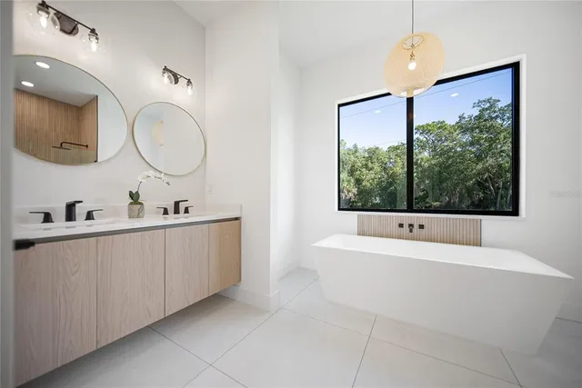 a large kitchen with kitchen island a sink a stove and a refrigerator
