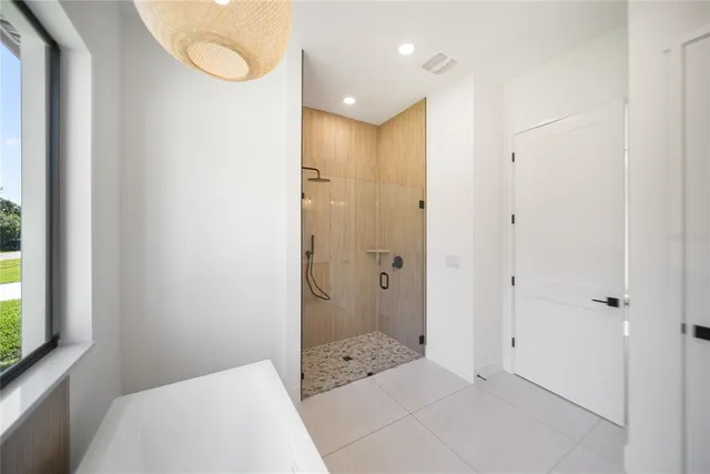 an empty room with wooden floor and a window