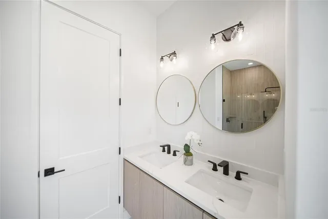 an empty room with wooden floor cabinet and windows