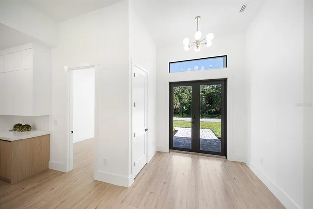 a view of a big room with wooden floor and windows