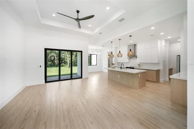 an aerial view of residential house with outdoor space and trees all around
