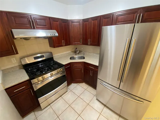 a kitchen with a refrigerator and a stove