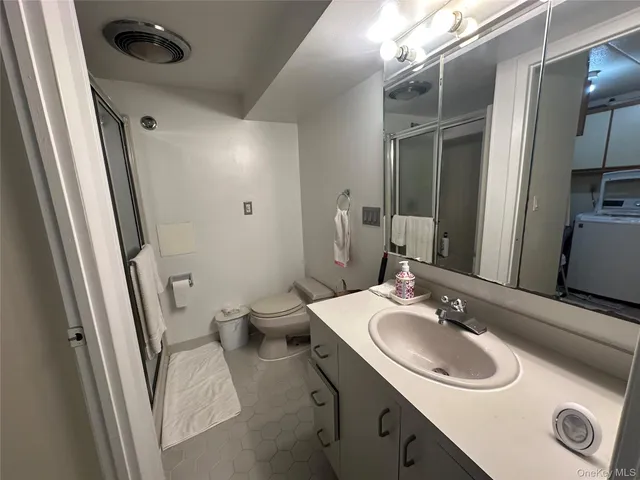 a white toilet sitting next to a sink