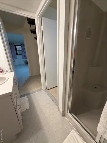 a bathroom with a sink a toilet and a mirror