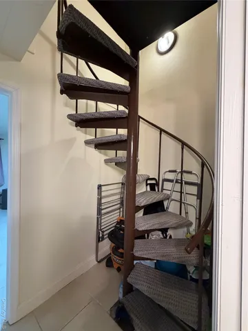 a kitchen with stainless steel appliances kitchen island granite countertop a refrigerator and a stove top oven