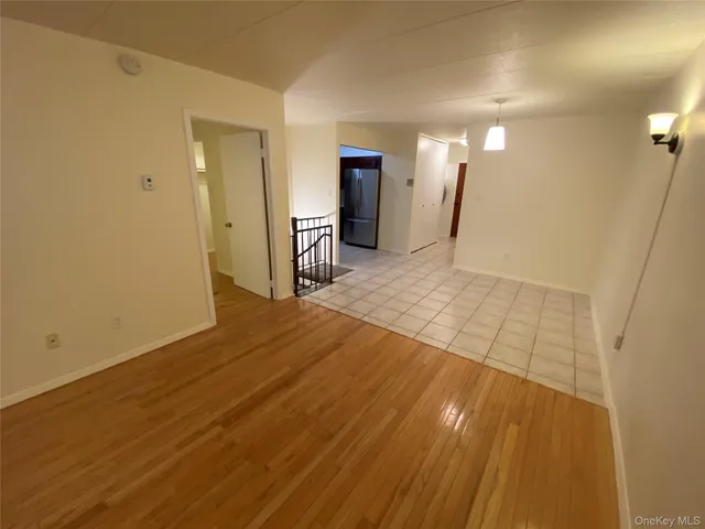 a view of a room with wooden floor