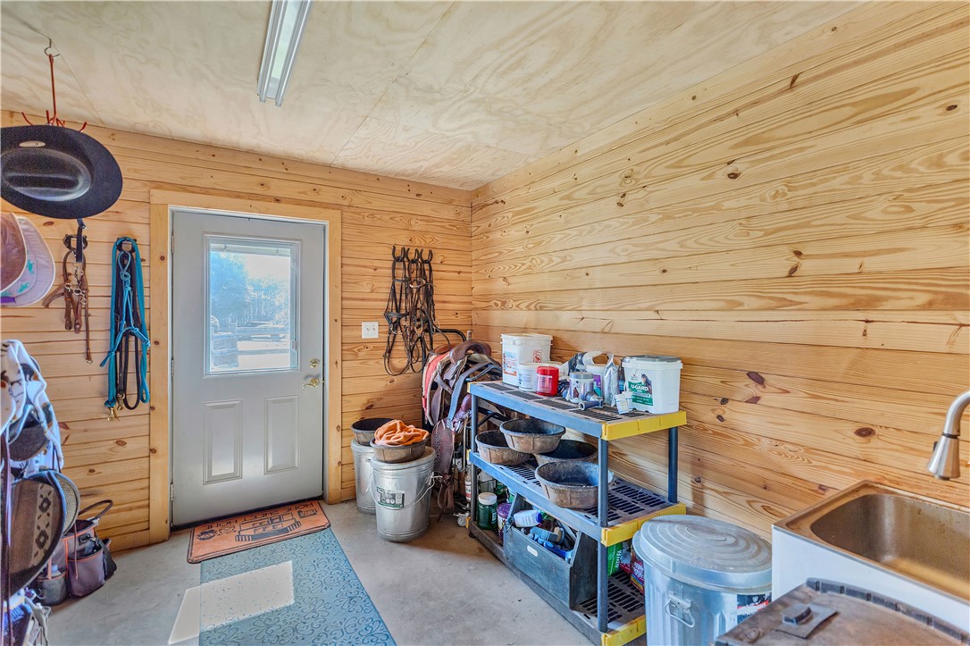3620 Centerville Road Anderson, SC 29625 - Photo 12 of 49 Natural wood paneling lines the walls of this functional workshop and storage space.