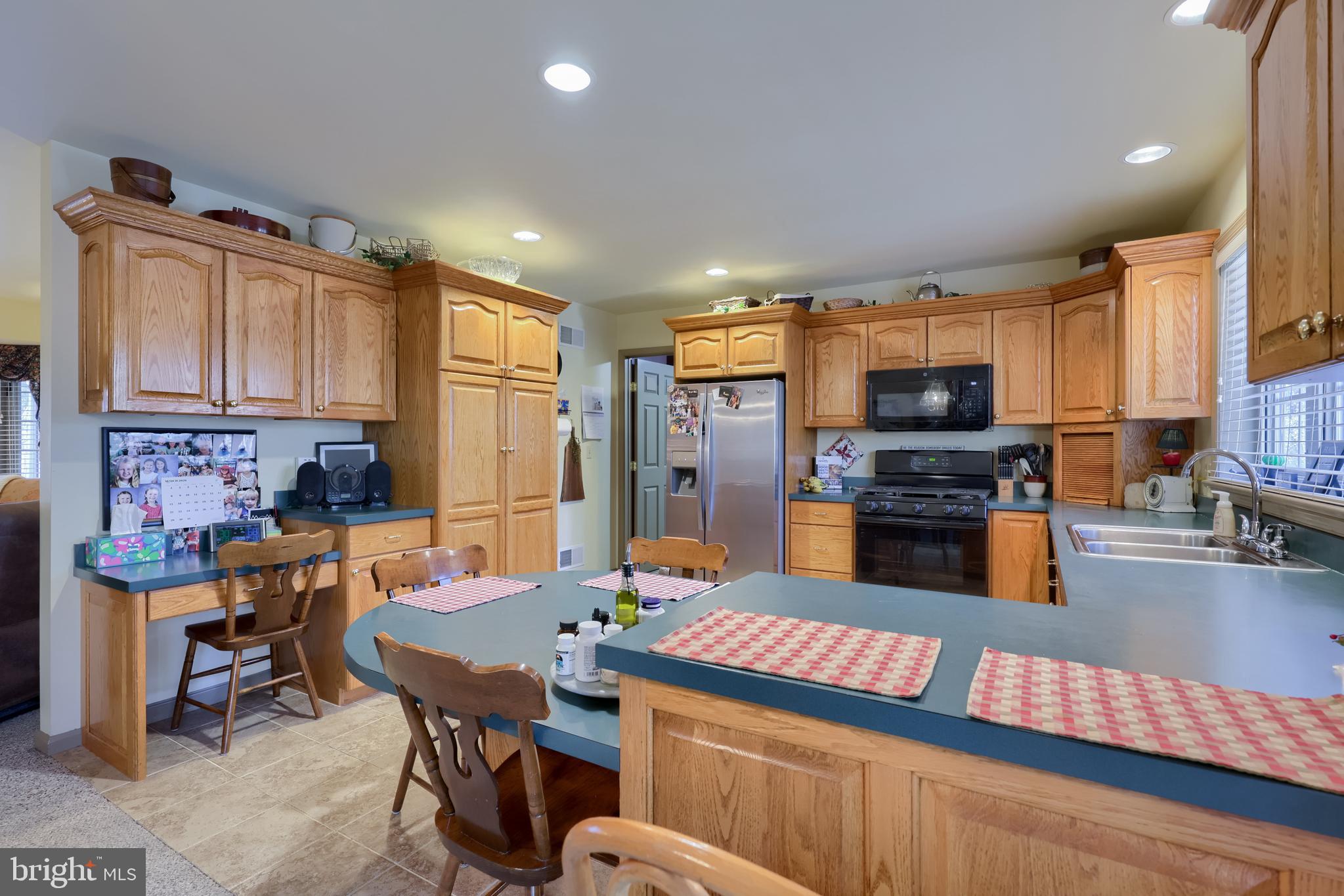1624 Springville Road New Holland, PA 17557 - Photo 41 of 85 a kitchen with stainless steel appliances wooden floor dining table and chairs