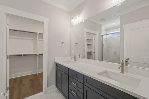 a bathroom with a sink double vanity and a mirror