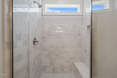 a bathroom with a glass shower door