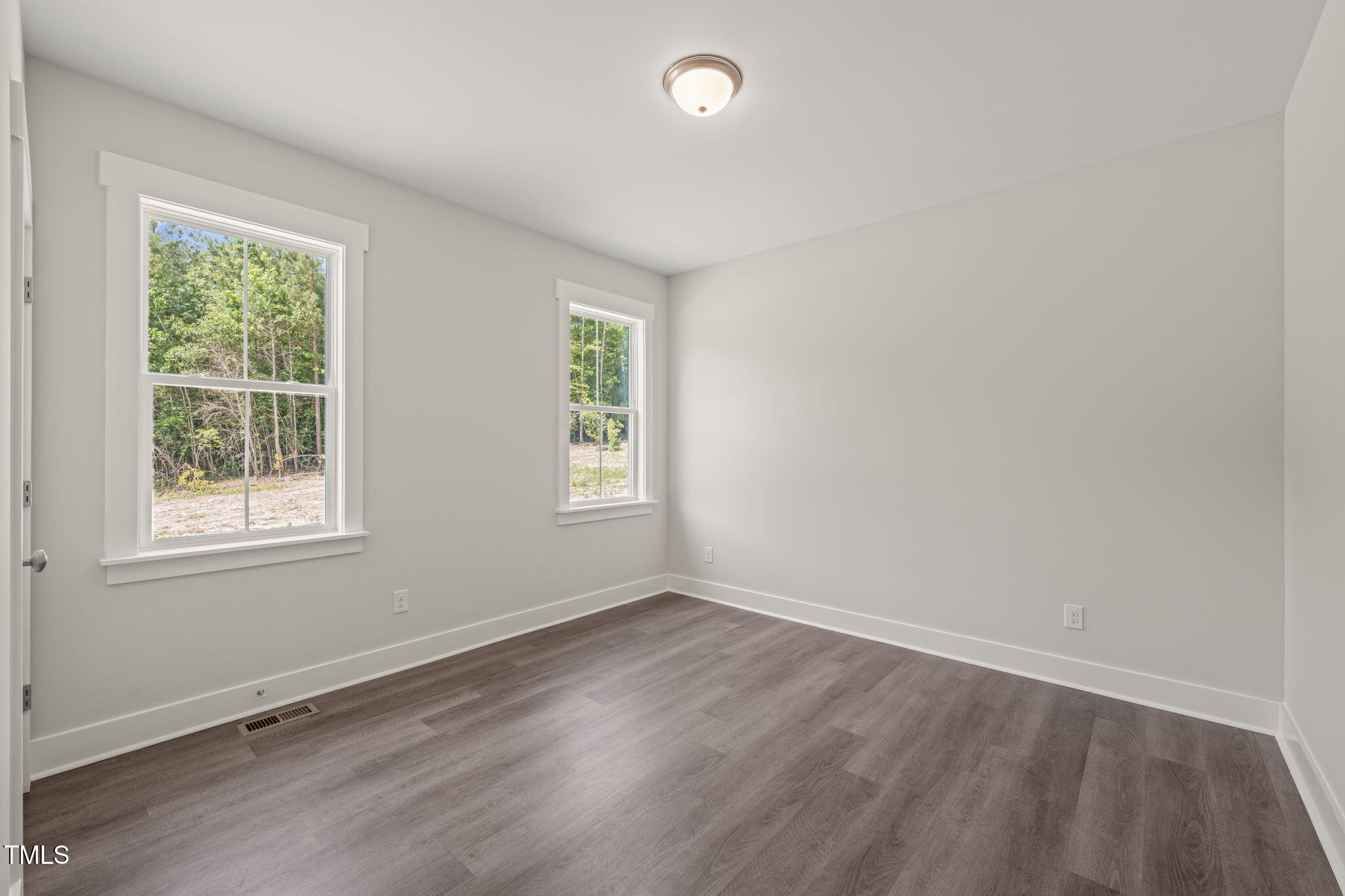 260 Pilot Ridge Road Zebulon, NC 27597 - Photo 22 of 39 an empty room with wooden floor and windows