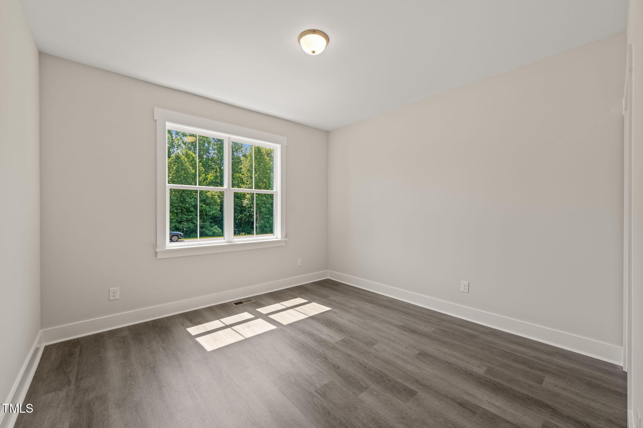 260 Pilot Ridge Road Zebulon, NC 27597 - Photo 25 of 39 an empty room with wooden floor and windows