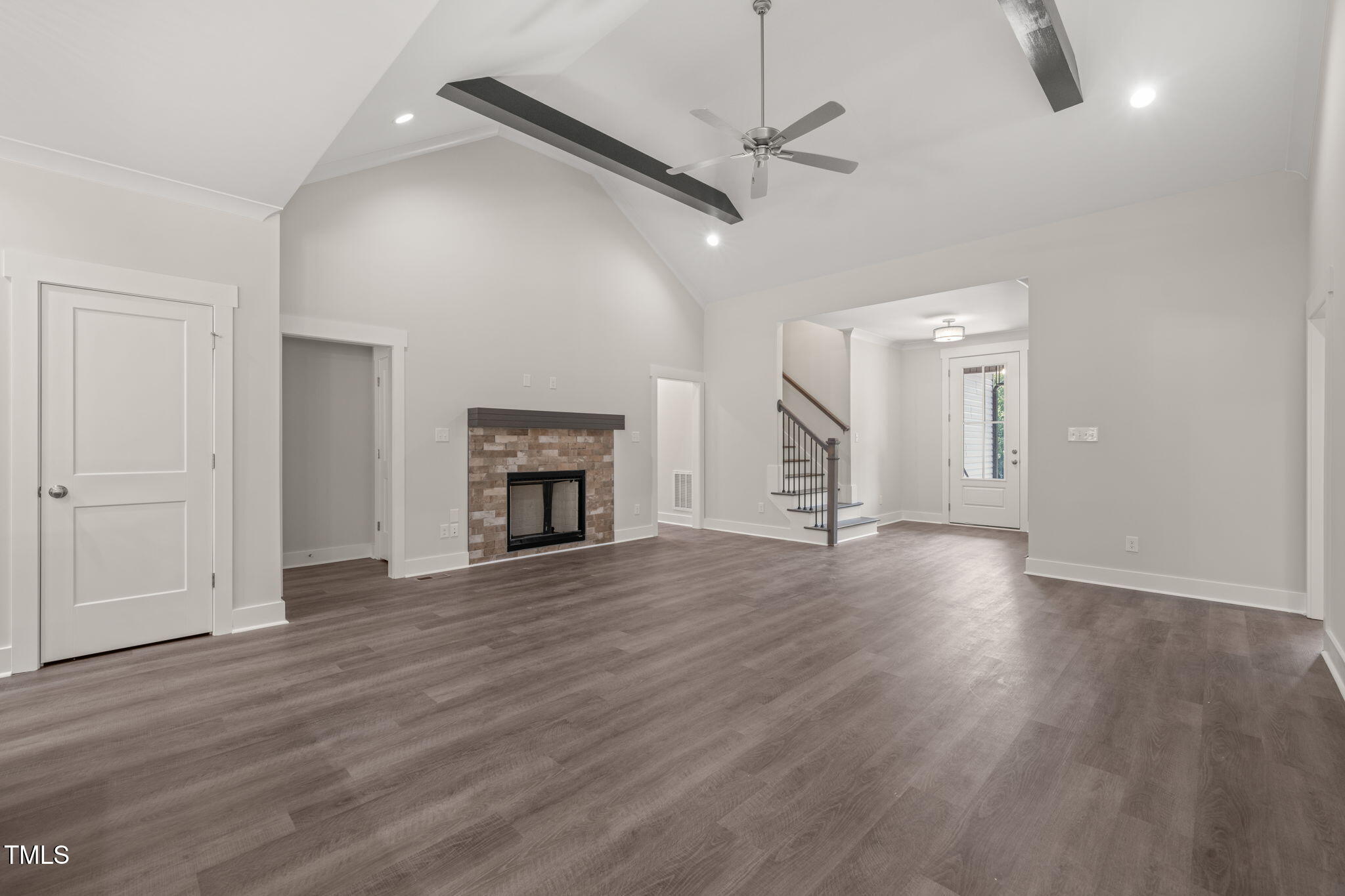 260 Pilot Ridge Road Zebulon, NC 27597 - Photo 5 of 39 an empty room with wooden floor fireplace and windows