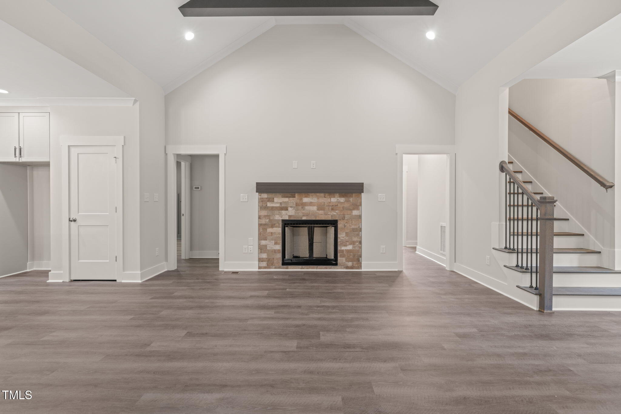 260 Pilot Ridge Road Zebulon, NC 27597 - Photo 6 of 39 a view of an empty room with wooden floor fireplace and a window