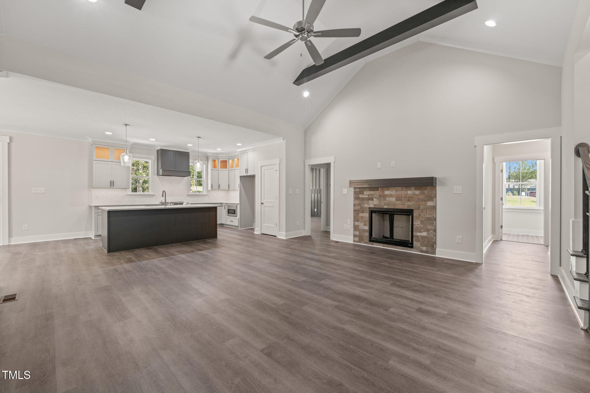 260 Pilot Ridge Road Zebulon, NC 27597 - Photo 7 of 39 a view of a livingroom with a fireplace a ceiling fan and wooden floor