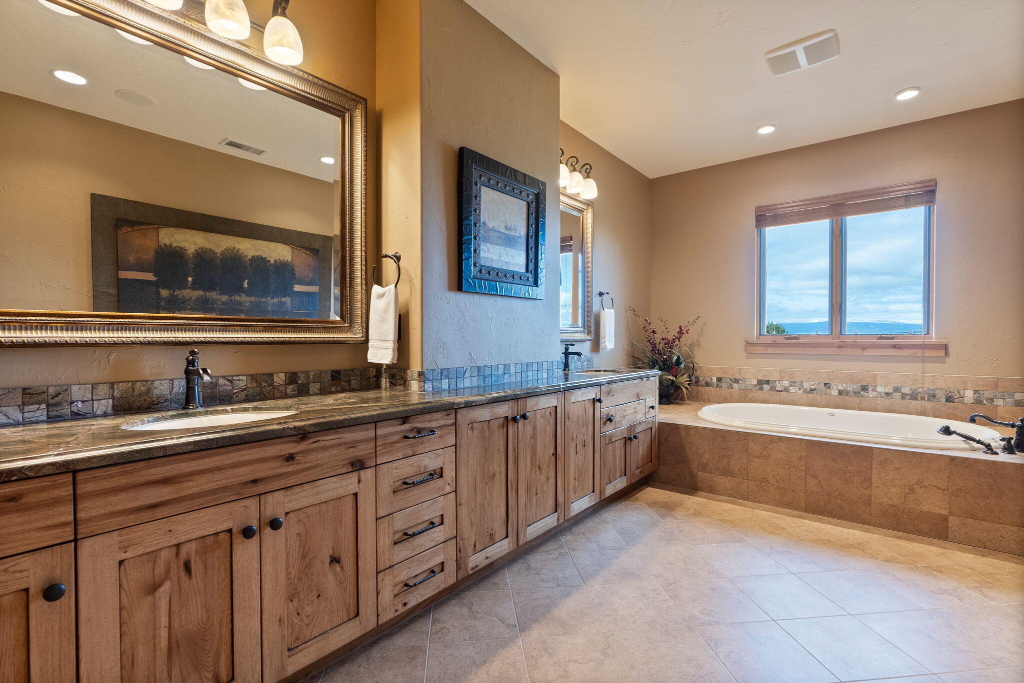 22887 Ghost Tree Lane Bend, OR 97701 - Photo 49 of 97 Luxurious primary bathroom with soaking tub, double vanity, granite counters, enclosed toilet & walk in closet