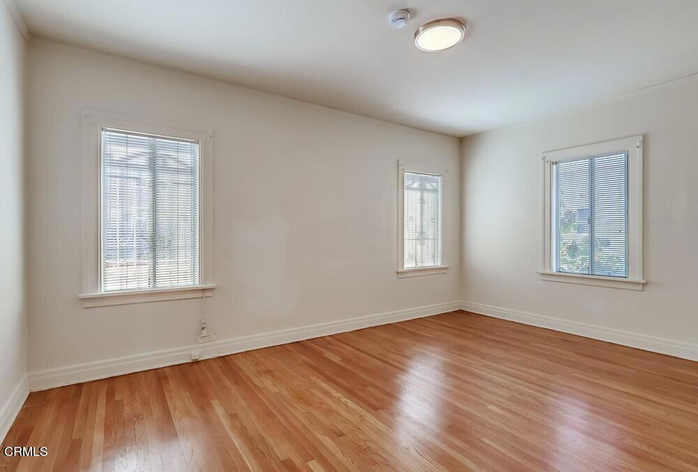 833-835 North Ridgewood Place Los Angeles, CA 90038 - Photo 11 of 28 a view of an empty room with wooden floor and a window