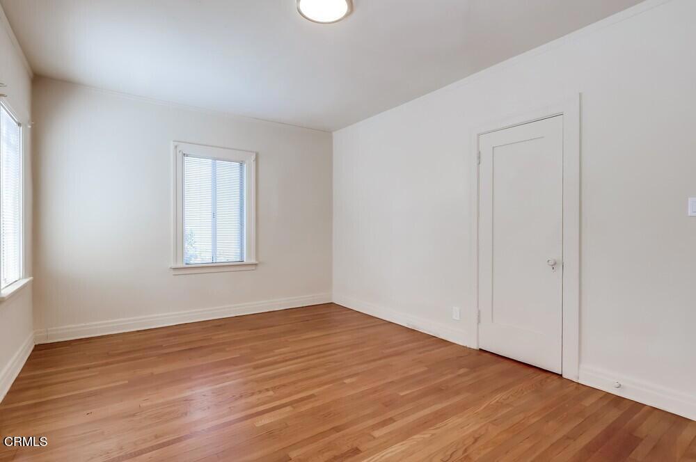 833-835 North Ridgewood Place Los Angeles, CA 90038 - Photo 12 of 28 an empty room with wooden floor and windows