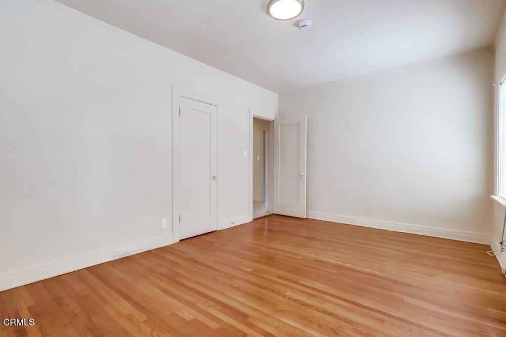833-835 North Ridgewood Place Los Angeles, CA 90038 - Photo 13 of 28 a view of empty room with wooden floor