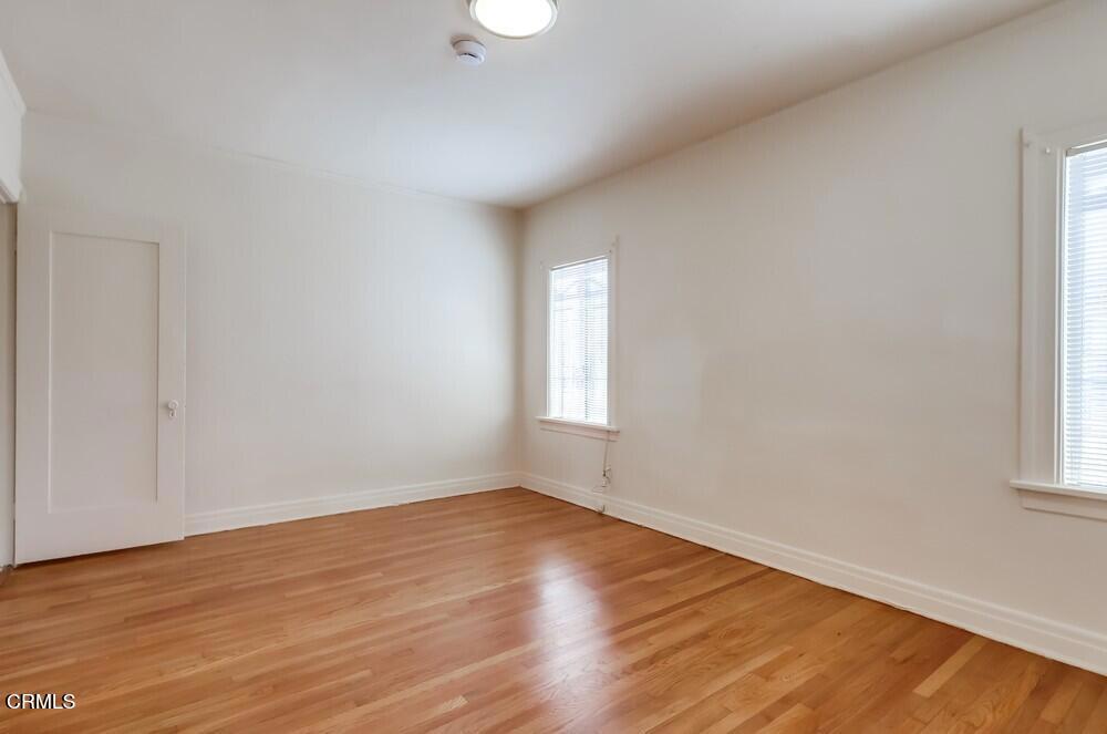 833-835 North Ridgewood Place Los Angeles, CA 90038 - Photo 14 of 28 a view of an empty room with wooden floor and a window