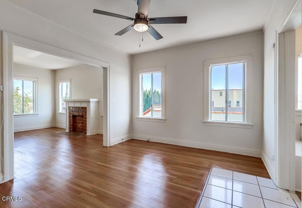 833-835 North Ridgewood Place Los Angeles, CA 90038 - Photo 8 of 28 a view of an empty room with window and wooden floor