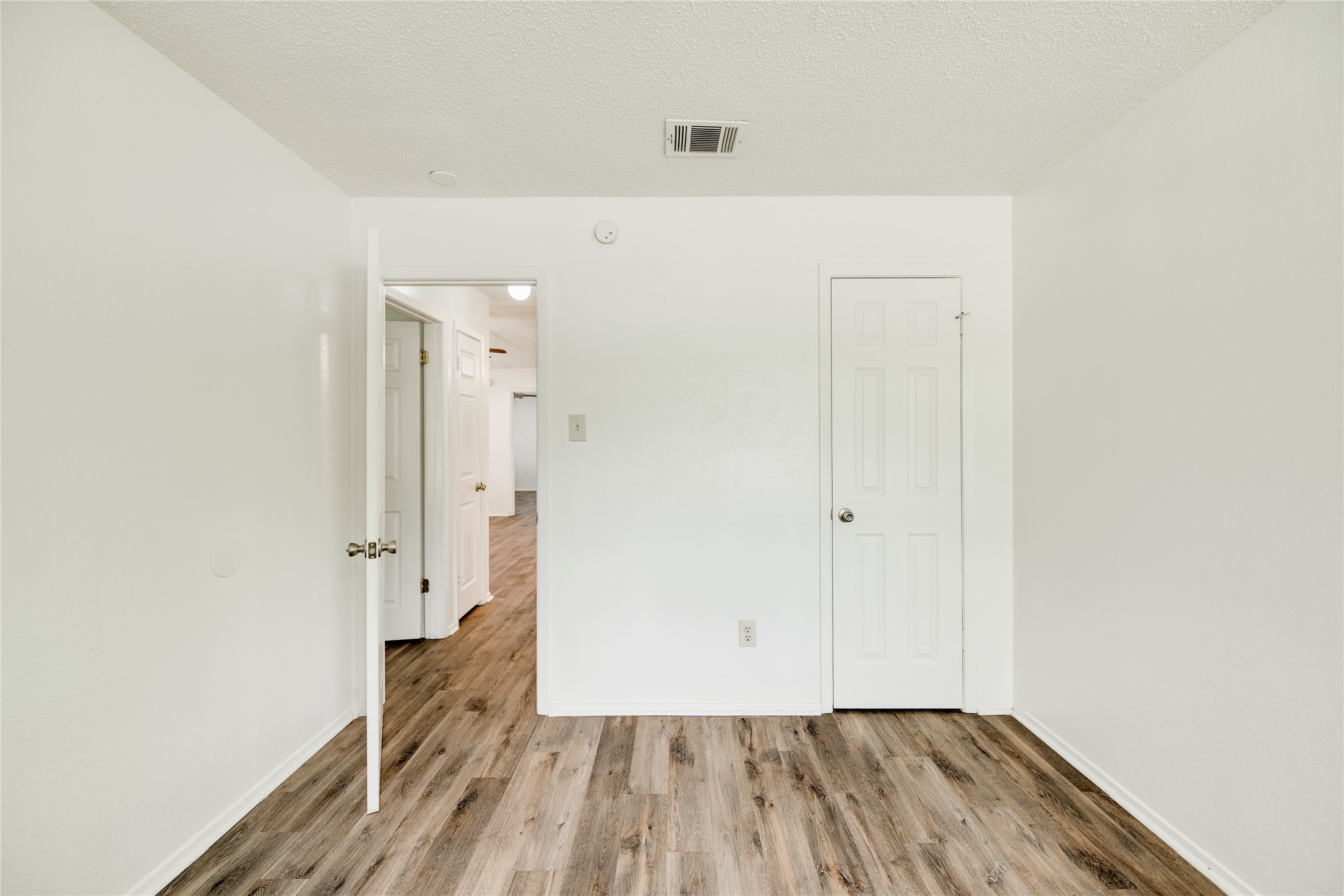 7918 West Gate Boulevard Austin, TX 78745 - Photo 5 of 31 Natural wood-look flooring extends throughout this versatile living space.