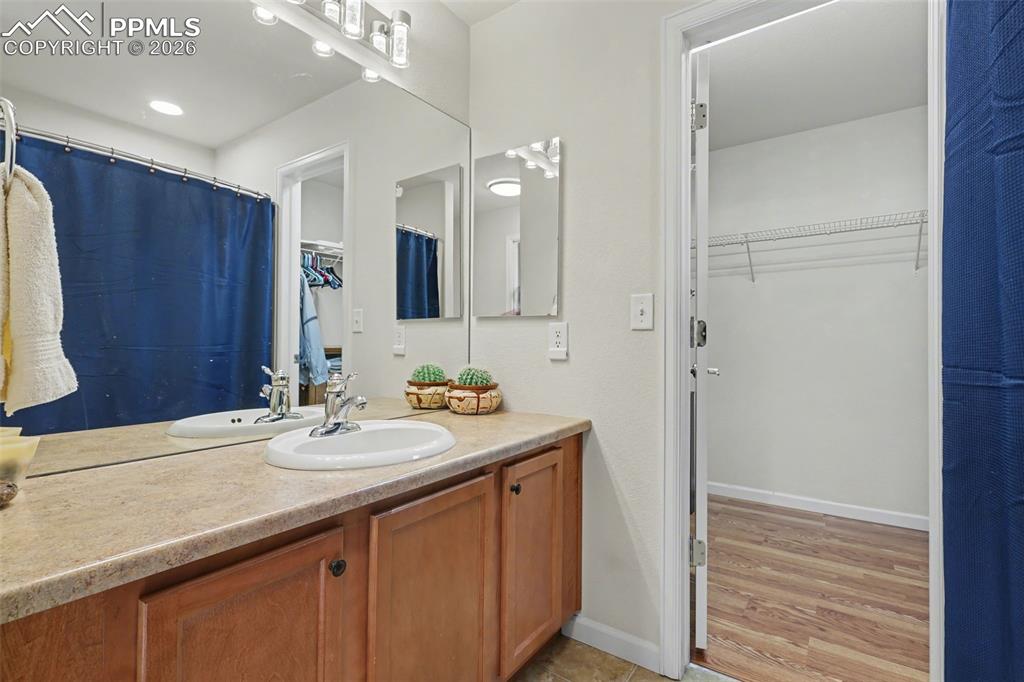17063 Blue Mist Grove Monument, CO 80132 - Photo 19 of 33 a bathroom with a sink a double vanity and a mirror
